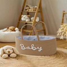 a baby basket sitting on top of a rug next to a stuffed animal