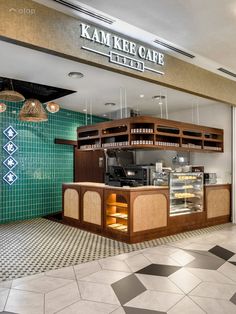 the inside of a restaurant with tiled floors and green tiles on the walls, along with an open counter