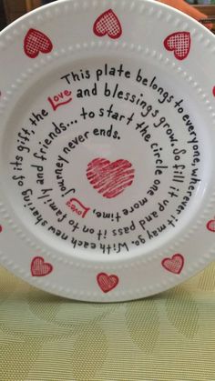 a white plate with red hearts on it and words written in the center that read, this plate belongs to father and his blessing