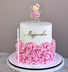 a white and pink cake with a fairy on top that says myogarala