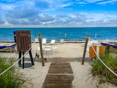 there is a wooden walkway leading to the beach