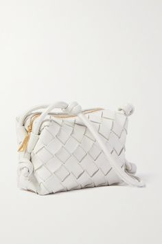 Bottega Veneta's 'Loop Candy' bag is made from strips of soft leather woven using the brand's signature intrecciato technique. It hangs from an adjustable knotted strap and has a compact interior with just enough space for the essentials. The white hue will offset neutral outfits. Designer White Bags With Intrecciato Weave, Designer Bags With Interwoven Design For Daily Use, White Intrecciato Weave Crossbody Bag, Woven Leather Bag, Bottega Veneta Bags, Fashion Collage, Leather Weaving, Best Bags, Mini Crossbody Bag