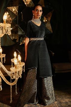 Black asymmetric top with pleated detailing. Paired with floral brocade woven ghaghra and velvet zardozi embroidered belt. - Aza Fashions Evening Palazzo Set With Sheer Dupatta And Traditional Drape, Evening Party Wear Palazzo Set With Zari Work, Elegant Raw Silk Evening Dress, Elegant Evening Raw Silk Dress, Elegant Evening Dress In Raw Silk, Evening Anarkali Kurta With Traditional Drape, Anarkali Style Palazzo Set With Mirror Work For Evening, Evening Palazzo Set With Sheer Dupatta For Eid, Festive Evening Palazzo Set With Zari Work