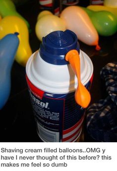 a plastic cup with an orange spoon sticking out of it next to balloons and other toys