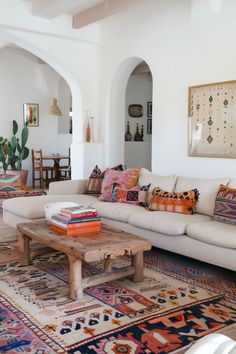 a living room filled with lots of furniture and rugs