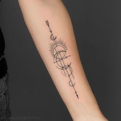 a woman's arm with a compass tattoo on the left side of her arm