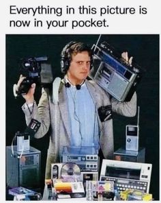 a man with headphones on holding up two boomboxs in front of his face