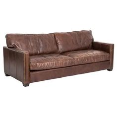 a brown leather couch sitting on top of a white floor