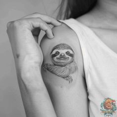 a sloth tattoo on the left arm and shoulder is shown in black and white