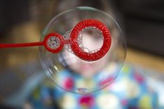 a close up of a wine glass with a red object in the middle of it