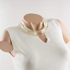 This is part of Chairish’s Costume Jewelry assortment.  An elegant Italian artisan designer studio collar choker necklace.  Lucite or resin rigid bib shape in translucent clear color ornate with silver flakes inclusions in an organic abstract free-form design. Silvered metal chain to adjust the length. No visible maker's mark. Measurements: The inner circumference is 16.57 in (42 cm) - the front height is 1 in (2.6 cm) - the opening is 3.38 in (8.5 cm) - the necklace will fit an average 14.57 in Clear Lucite Party Jewelry, Elegant Resin Necklaces For Party, Adjustable Elegant Resin Necklace, White Resin Necklaces, Elegant Lucite Jewelry For Formal Occasions, Elegant Resin Jewelry For Wedding, Elegant Clear Resin Jewelry, Elegant White Resin Jewelry, Modern White Lucite Jewelry