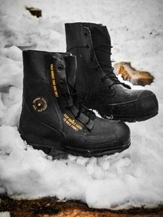 two black boots are sitting in the snow