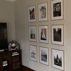 a living room with pictures on the wall and a flat screen tv in the corner