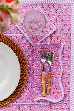 the table is set with silverware and pink placemats, which are decorated with hearts