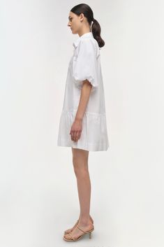 SIGNATURE COLLECTION The Crissy Dress in White. Casual, wear-everywhere shirting inspired mini dress with a relaxed, puffed fit and ballooned short sleeves. Casual Mini Dress, One Piece Clothing, Mini Dress Casual, White Shirt Dress, Knitwear Tops, Mini Shirt Dress, Romper With Skirt, Signature Collection, Shop Swimwear