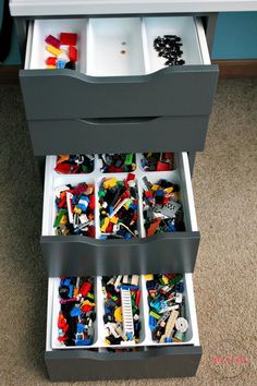 the drawers are filled with legos and toys