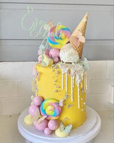 a yellow cake decorated with ice cream and candies