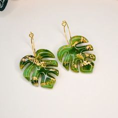 a pair of green and gold leaf earrings