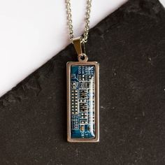 Cool necklace made with a piece of a real circuit board is an amazing accessory for a geek and techie lover. This necklace is definitely a conversation starter!The base and the chain is stainless steel. The pendant is covered with clean resin, so the surface is smooth and shiny.The circuit board piece is 10x30mm (3/8"x1 1/8"). The chain is 60cm (23 1/2") in length. Want it shorter? Let us know in the comments to your order.You may choose your color from the list below: - blue - dark blue - red - Computer Nerd Gifts, Computer Geek Gifts, Computer Nerd, Tech Jewelry, Computer Geek, Computer Parts, Assemblage Jewelry, Resin Craft, Rainbow Bracelet