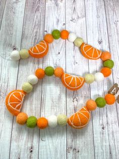 an orange and white beaded necklace on a wooden table