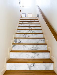 the stairs are made of marble and wood