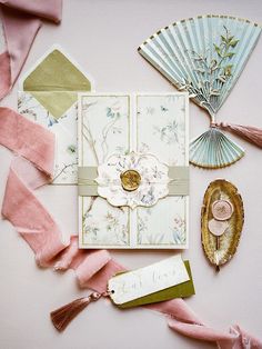 an assortment of decorative items are laid out on a table with ribbons and paper decorations