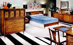 a bedroom scene with focus on the bed, dressers and desk in the foreground