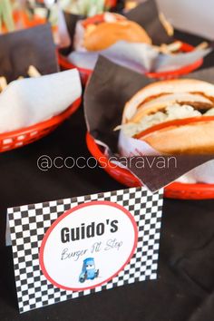 some food is sitting on a table with black and white checkered paper napkins