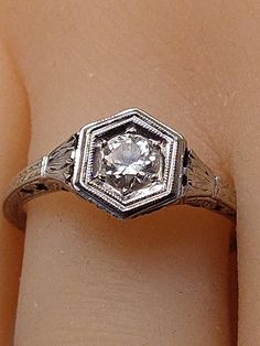 "This vintage ring is a winner in every respect. A beautiful Antique Engagement Ring circa 1900s. Art Deco 18k white gold marked. You can see it in the pic. Very faint from wear but it is there. The diamond is estimated and judged to be between .45 and .48 total carat weight. SI clarity, H/I color range. European cut diamond, Near colorless. Very sparkling and beautifully faceted. Tested and confirmed by my local jeweler who is in business over 30 years. Beaded 6 sided framework surrounds the so Art Deco Diamond Ring With Diamond Cut, Vintage Diamond Jewelry With Center Stone, Heirloom Brilliant Cut Diamond Ring Collectible, Vintage Rose Cut Round Diamond Ring, Antique Collectible Platinum Ring, Heirloom Collectible Round Cut Diamond Ring, Victorian Diamond Ring With 17 Jewels, Art Deco Ring With 17 Jewels In Round Cut, Victorian Platinum Diamond Ring With Hallmark