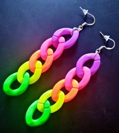 Rainbow colours chain earrings. Glows bright neon under UV light. Chain is about 7.5 centimetres. Please note that this is a different style to any other similar rainbow chain earrings that might also be listed. Very light weight to wear. Silver plated fishhooks. Colorful Plastic Jewelry For Party, Trendy Neon Jewelry, Rainbow Plastic Party Jewelry, Neon Yellow Trendy Jewelry For Party, Trendy Neon Jewelry For Party, Trendy Neon Yellow Jewelry For Party, Neon Jewelry, Colourful Earrings, Light Chain