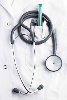 a doctor's stethoscope and other medical supplies on a white sheet