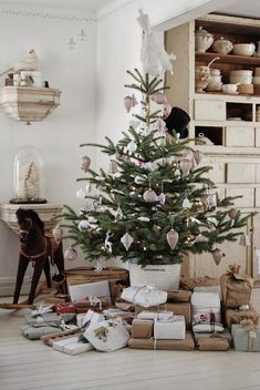 a small christmas tree is surrounded by presents