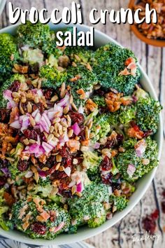 broccoli and cranberry salad in a white bowl on a wooden table