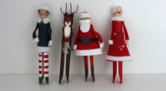 three christmas dolls standing next to each other