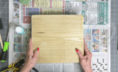 a person is making a wooden board out of plywood planks with scissors and glue