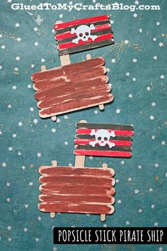 popsicle stick pirate ship craft for kids with stars and stripes on the bottom, one is