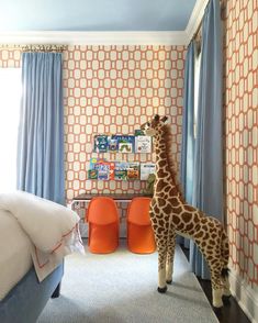 a giraffe standing in the middle of a bedroom