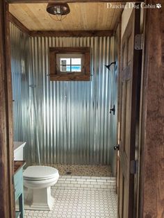 an open door leading to a bathroom with a toilet