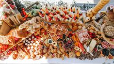 a table topped with lots of different types of foods and desserts on top of it