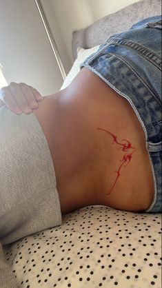 a woman's stomach with red ink on it