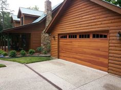 a large wooden garage in front of a house