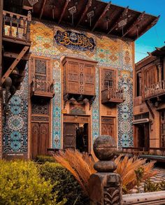 an intricately decorated building with wooden doors and balconies in the middle of it