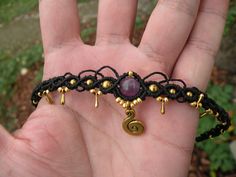 Amethyst Black Macrame Choker Tiara with Golden beads, Witchy Tribal Hippie Necklace, Gemstone Healing Crystal Brass Headband This boho choker / tiara / headband is created using the macrame technique. It is made by a high quality black waxed thread and beautiful Amethyst beads. Also we added a golden beads and charms to complete the design. Waxed thread gives the product durability and strength, and elegant natural appearance.  It's a beautiful gift and a nice accessory what you can wear every day.  Choker / Tiara characteristics: *This choker is adjustable, with a sliding knot, so matched to any width of the neck. *Amethyst bead 8mm  *Golden beads are 2 mm and 4 mm *No color fading --------All items made with a lot of dedication, patience and love --------Choker will arrive nicely packag Purple Festival Jewelry With Black Beads, Purple Jewelry With Black Beads For Festival, Adjustable Amethyst Jewelry For Festival, Adjustable Gemstone Beads Choker For Festival, Adjustable Purple Necklace With Black Beads, Macrame Choker, Tiara Headband, Black Macrame, Golden Beads