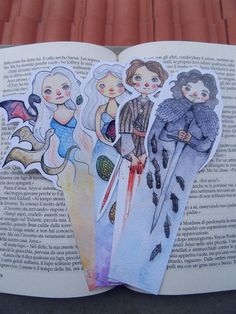 an open book with paper cutouts of people on it's pages and the title written in spanish