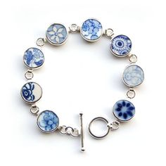 a bracelet with blue and white flowers on it is shown in the middle of a circle