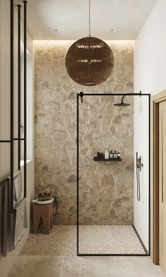 a bathroom with stone walls and flooring next to a walk - in shower area