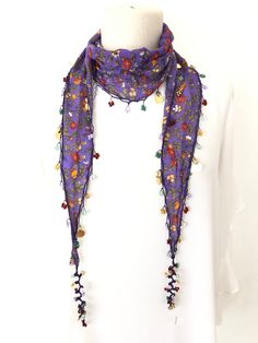 Cotton scarf with flower prints. All edges are hand crocheted with beads. Can be used as a necklace, necktie or bandana. Produced in pet and smoke free environment. Please wash by hand with warm water and soap.  Fabric length 1.5 meters (59inch)               widest part 22cm (8,66inch)             +-3 cm. There is five different ways to tie, as shown in the last picture. As one of my customer says; It is feminine & feels as light as a feather around my neck. The beads and disks are very appealing as they sparkle with movement and in light. I am going to love wearing this scarf and will wear it with jeans, dresses & business suits. Beautiful! Thanks so much.  EXPRESS Shipping Upgrade for 4+ pieces   Buy at least 4 pieces, I will send your order by express delivery service instead of airmai Turkish Lace, Beaded Scarf, Purple Scarf, Crochet Heart Pattern, Fabric Jewellery, Scarf Bandana, Purple Scarves, Scarf Necklace, Light As A Feather