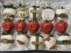 chocolate covered strawberries in the shape of gucci's strawberrys are decorated with gold and red ribbons