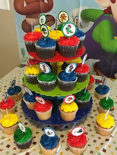 cupcakes are arranged in the shape of a tree on top of a table