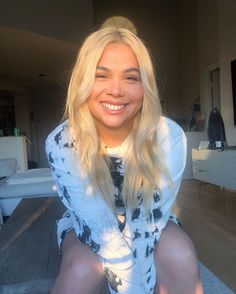 a woman sitting on top of a white couch